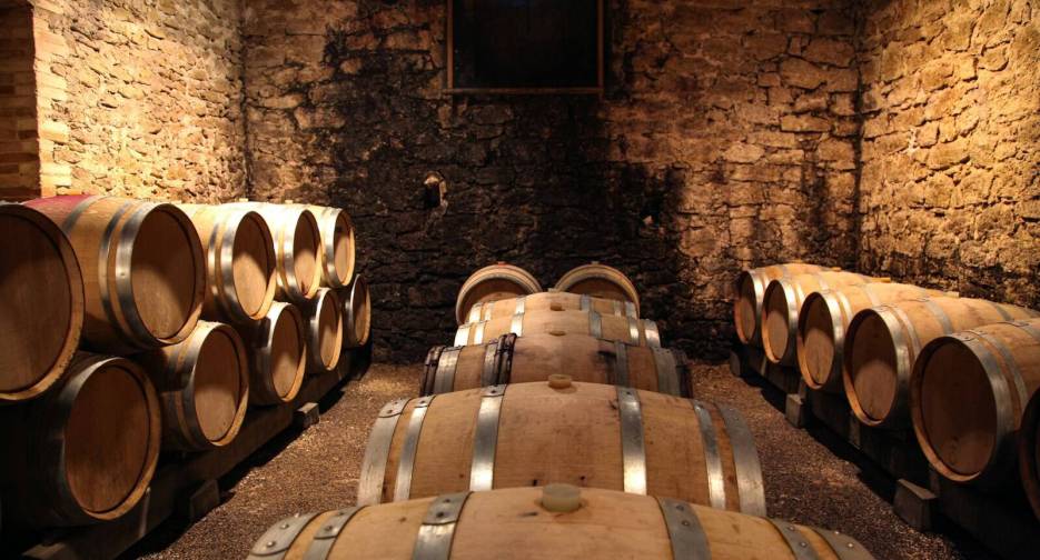 brown wooden barrels on brown brick wall